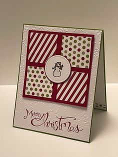 a close up of a christmas card on a white table with a red and green background