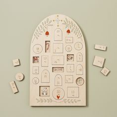 a white board with many pictures on it and some magnets in the shape of a house