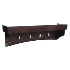 a wooden shelf with three hooks on it