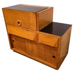 a wooden cabinet with two drawers on the front and one drawer open to show its contents