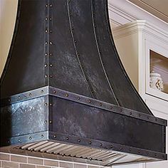 a large black stove top oven sitting inside of a kitchen