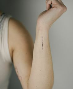 a woman's arm with a small tattoo on the left side of her arm