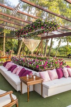 a white couch covered in lots of pink and purple flowers