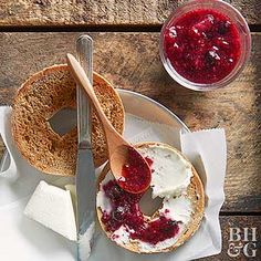 a bagel with cream cheese and jam on it