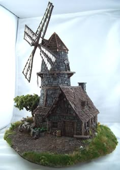 a small house with a windmill on top of it