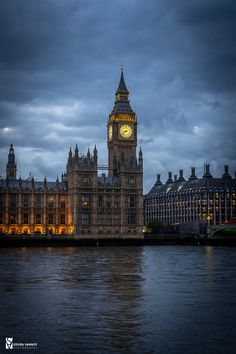 the big ben clock tower towering over the city of london, england at night time