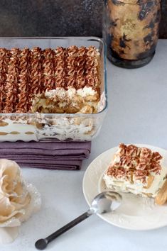 two plates with desserts on them next to a glass jar and spoon in the background