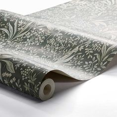 an image of a wallpaper with flowers and leaves on the side that is rolled up