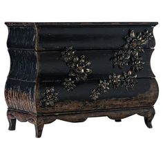 an antique chest with flowers painted on the front and sides, is shown in black