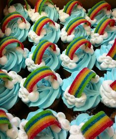 cupcakes with blue frosting and rainbow decorations