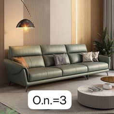 a modern living room with green leather couches and round coffee table in the middle