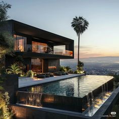 a large pool in front of a modern house with palm trees and mountains behind it