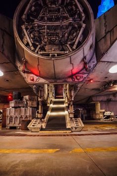 the inside of an airplane with stairs leading up to it's landing area and lights on