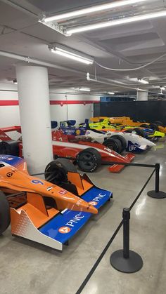 several race cars are lined up in the garage