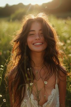 a beautiful young woman standing in the middle of a field with daisies on her chest