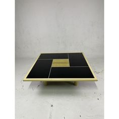 a ping pong table with black and yellow squares on it