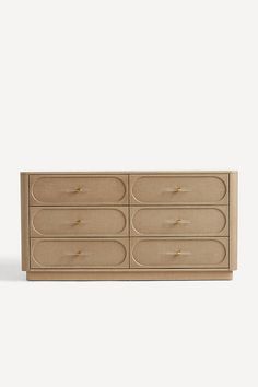 the sideboard is made out of wood and has four drawers, one with gold handles