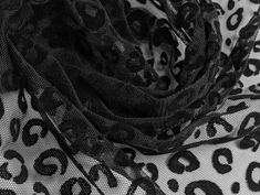 a black and white photo of an animal print scarf