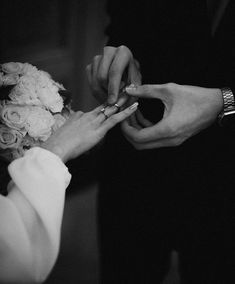 the bride and groom are exchanging their wedding rings