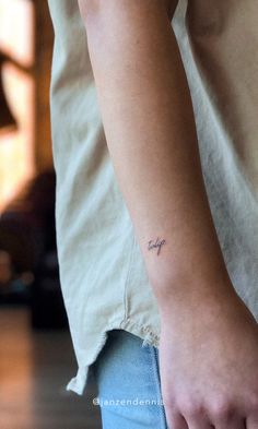 a person with a small tattoo on their arm