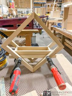 some tools are sitting on a table in a room filled with woodworking supplies and other items