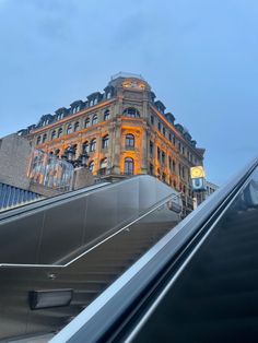 an escalator in front of a large building