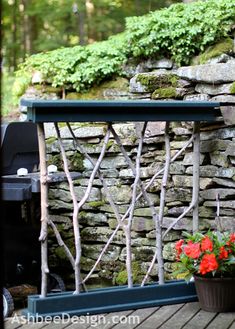 a potted plant sitting on top of a wooden table next to a stone wall