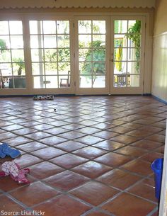 an empty room with tiled floors and sliding glass doors