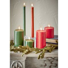 three candles are sitting next to each other on a mantle