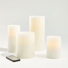 Warm White Flameless Wax Candles | Crate and Barrel Wire Candle Holder, Candle Alternatives, Modern Halloween Decor, Ivory Pillar Candles, Ivory Candles, Christmas Entryway, White Pillar Candles, Bottle Brush Christmas Trees, Flameless Candles