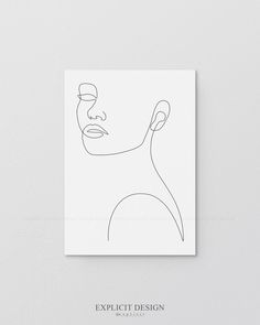 a white square with a line drawing of a woman's face on the wall