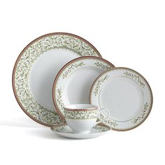 a white and green dinner set with gold trimmings