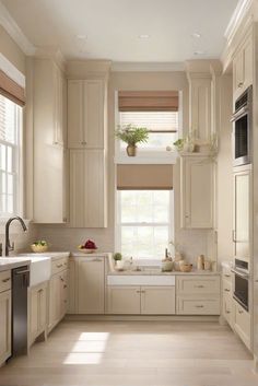 a kitchen filled with lots of white cabinets and counter top space next to a window