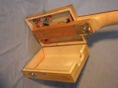 an open wooden box with various items inside