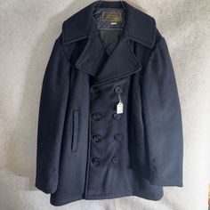 This vintage peacoat from Harbour Park is a true gem for any collector. With a classic navy blue color and a stylish pea coat design, it's perfect for both casual and formal occasions. The outer shell is made of high-quality wool, ensuring both comfort and durability. The size 34 coat is designed for men and features a regular fit. The brand is known for its rare and unique designs, making this a one-of-a-kind piece. It comes with tags and is in excellent, like-new condition. This peacoat is per Pea Coat Men, Navy Peacoat, Peacoat Men, Coat Men, Coat Design, Navy Blue Color, Pea Coat, Us Navy, Formal Occasion