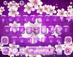 a purple keyboard with white flowers on the keys and letters below it, in front of a purple background