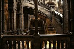 the inside of a building with stairs and arches