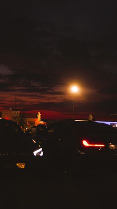 cars parked in a parking lot at night