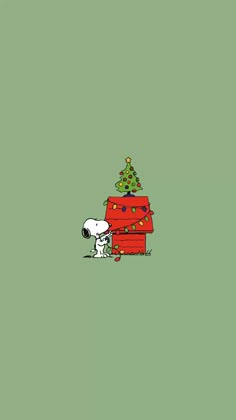 snoopy and his christmas tree are on the green wall