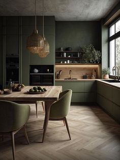 a kitchen with wooden floors and green walls, along with an island table surrounded by chairs