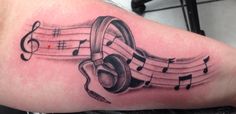 a tattoo with musical notes on it