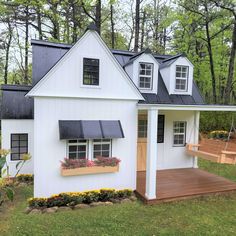 a white house with black roof and windows