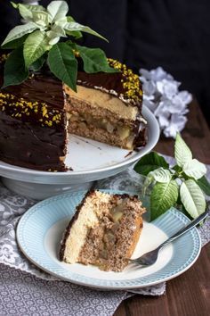 a piece of cake on a plate with a fork next to it and another slice in the background