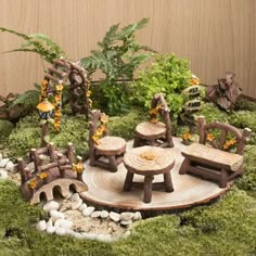 a miniature garden made out of wood and moss