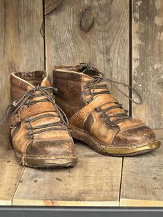 Two-tone Vintage Ski Boots c. 1940's Sole and boot length 11.5", ~ size 8 Wood, Metal (nails), Leather © Vintage Winter A great set of old vintage leather ski boots used for downhill skiing in the 1940's. These two-tone leather ski boots have brass toe reinforcements, inner eyelets and feature a boot lace system with a leather tongue. There is a stamp that reads '300' on the sole. A great decoration for your winter decor or ski chalet. They are in good condition and have been well taken care of throughout the years.  Jumping a cornice on old wood skis. Vintage Lace-up Boots With Leather Footbed, Vintage Brown Round Toe Boots For Outdoor, Rugged Vintage Brown Boots For Outdoor, Vintage Snip Toe Work Boots With Leather Sole, Vintage Patina Boots With Round Toe, Rustic Boots With Vibram Sole And Round Toe, Vintage Lace-up Moto Boots With Leather Footbed, Vintage Moto Boots With Leather Footbed And Round Toe, Vintage Moto Boots With Leather Footbed