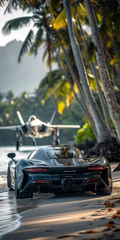 a black sports car parked on the beach next to palm trees and an airplane in the background