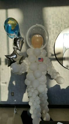 an astronaut balloon sculpture is shown with balloons