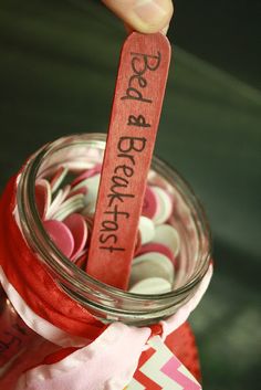 a jar filled with lots of different types of buttons next to a wooden sign that says best friends