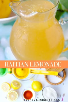 a pitcher filled with lemonade sitting on top of a table next to other ingredients