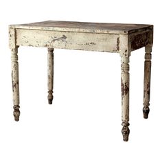 an old white table with wooden legs